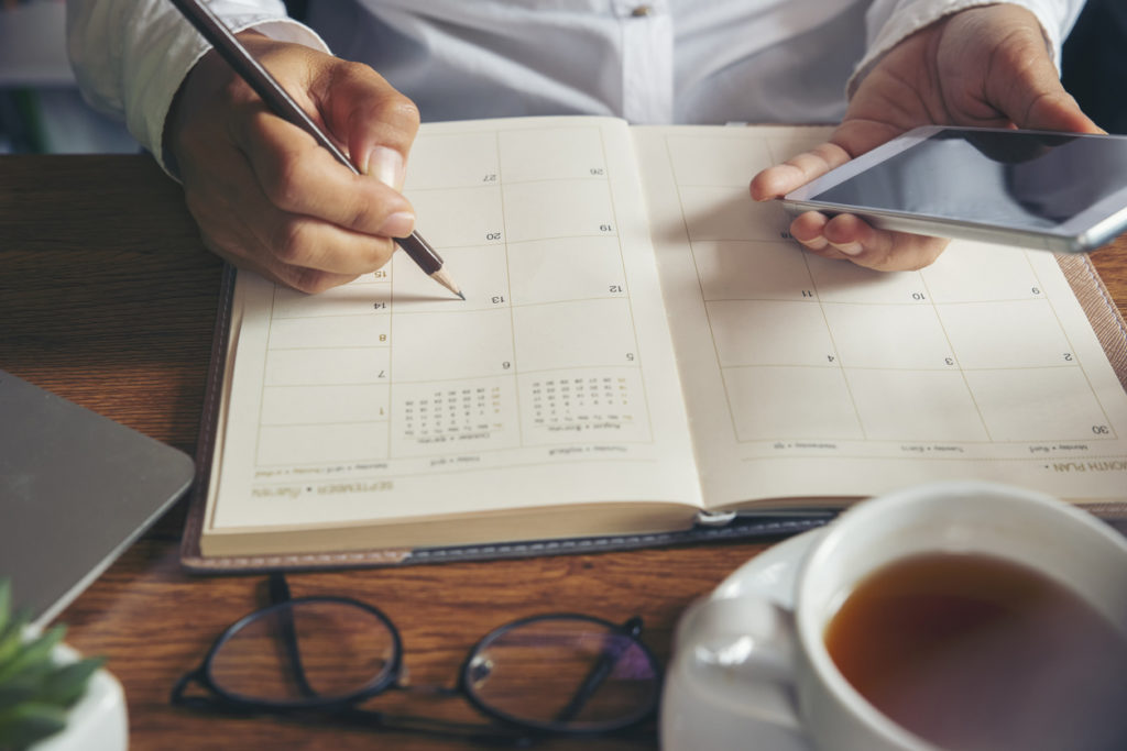 Woman writing in her agenda