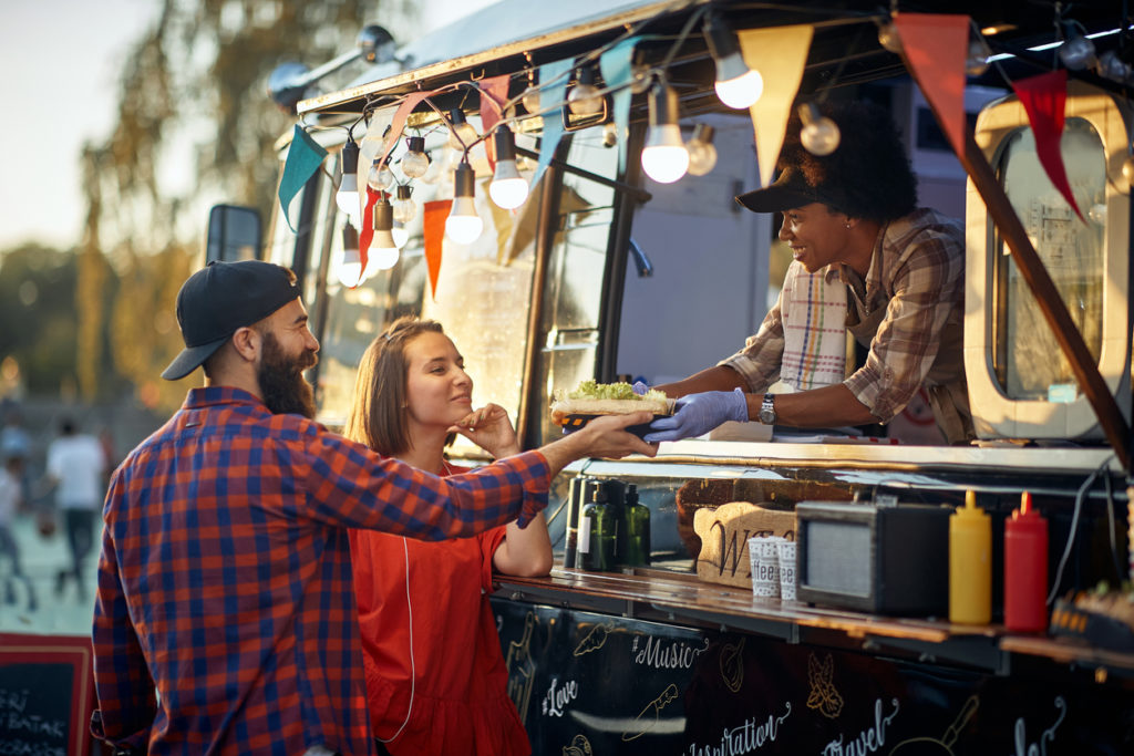 satisfied couple taking ordered sandwiches from an polite and friendly and polite employee