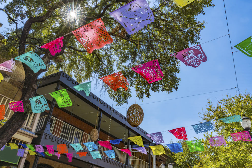 paper decorations in the air with trees above the Market Square