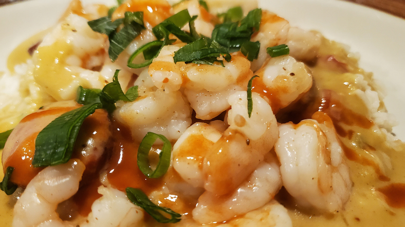 A delicious looking bowl of shrimp or seafood etouffee with green onions