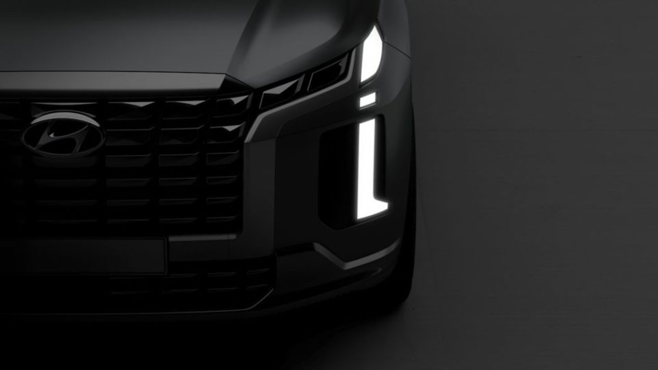 Black 2023 Hyundai Palisades on a smoky gray background.